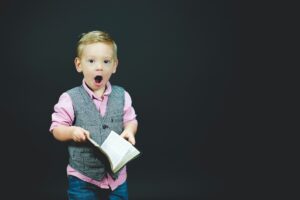 excited looking boy with Bible